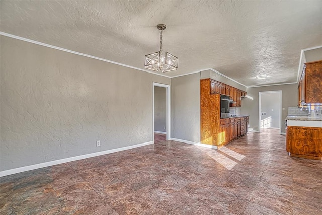 unfurnished living room featuring crown molding, a textured wall, and baseboards