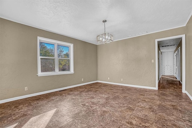 spare room with visible vents, baseboards, a textured ceiling, and a textured wall