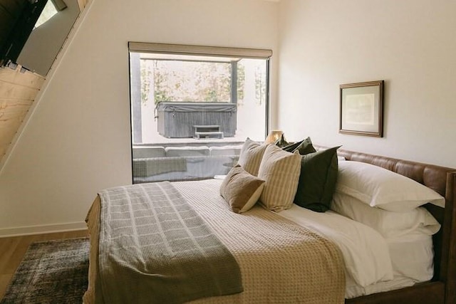 bedroom with hardwood / wood-style flooring