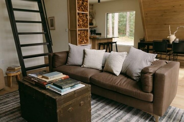 living room with hardwood / wood-style floors and wood walls