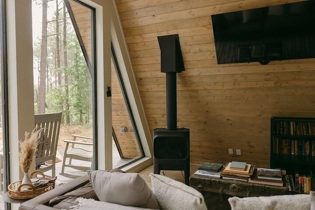 interior space featuring wood walls and a wood stove