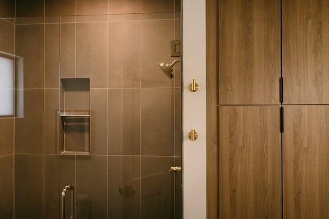 bathroom featuring a shower with shower door