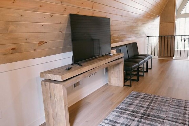 living area with wood ceiling, lofted ceiling, wooden walls, and light hardwood / wood-style flooring