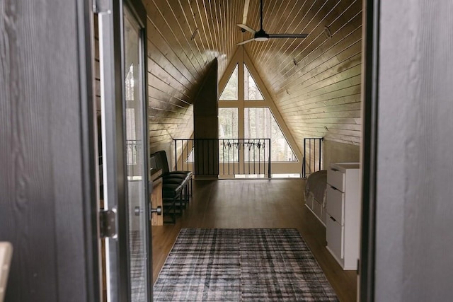 bonus room with ceiling fan, dark wood-type flooring, wooden ceiling, lofted ceiling, and wood walls