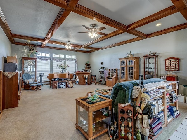 carpeted living room featuring beam ceiling, crown molding, ceiling fan, and coffered ceiling