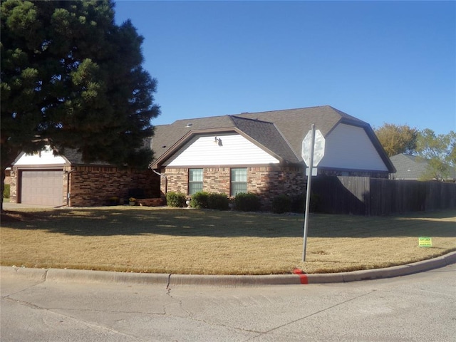 view of front of property featuring a front yard and a garage