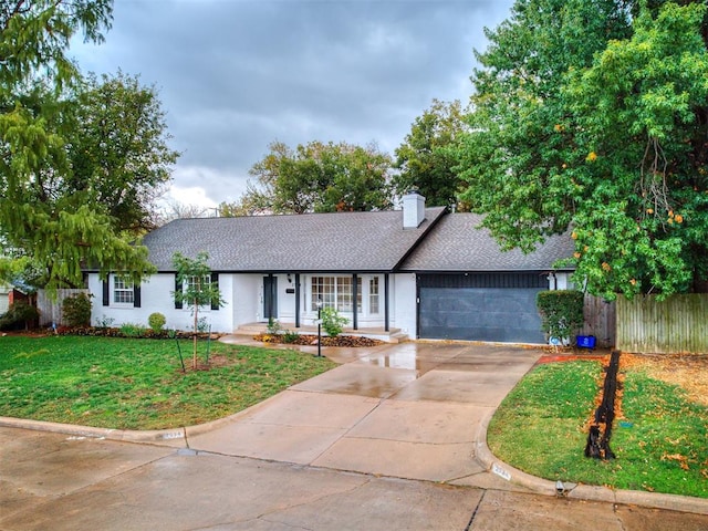 single story home with a front yard and a garage