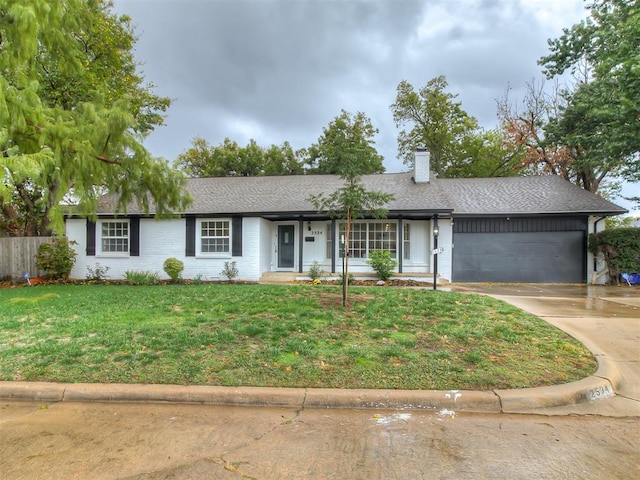 ranch-style house with a garage and a front lawn