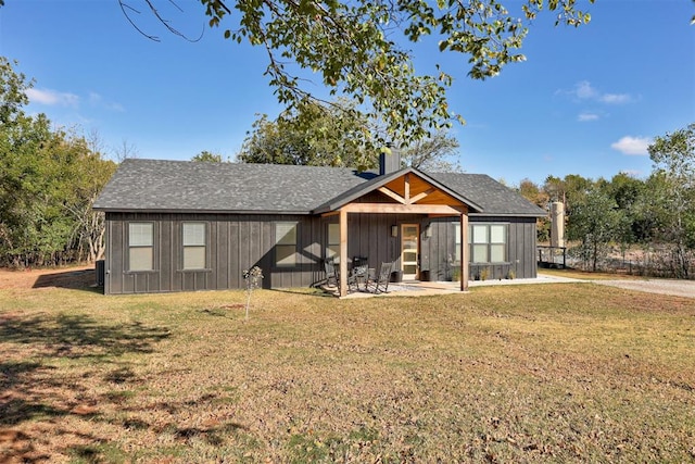 rear view of house featuring a patio area and a yard