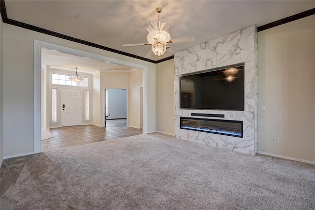 unfurnished living room featuring carpet floors, ceiling fan, crown molding, and a premium fireplace