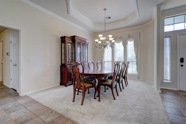 dining space with a notable chandelier, a raised ceiling, ornamental molding, and light carpet