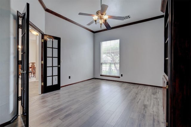 spare room featuring french doors, light hardwood / wood-style floors, ceiling fan, and ornamental molding