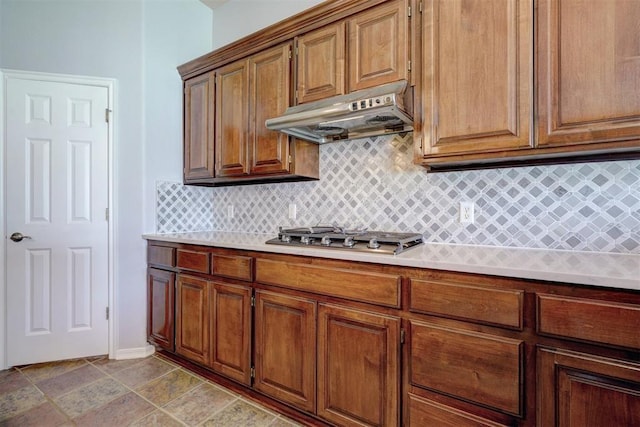 kitchen with tasteful backsplash, ventilation hood, and stainless steel gas cooktop