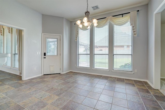 unfurnished dining area with a chandelier