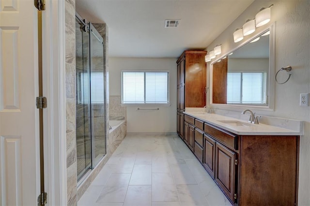 bathroom featuring plus walk in shower, tile patterned flooring, and vanity