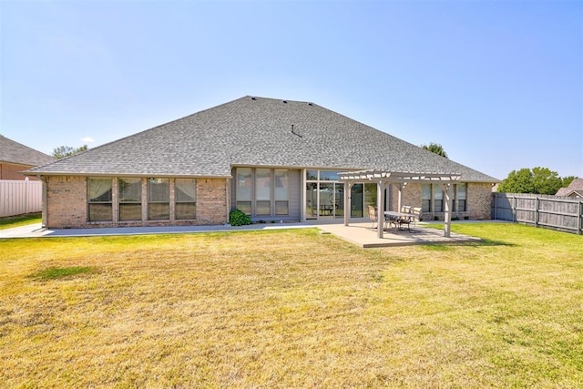 rear view of property featuring a pergola, a yard, and a patio