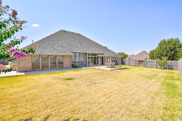 rear view of house with a lawn, a pergola, and a patio