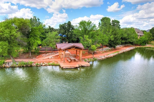 view of dock with a gazebo and a water view