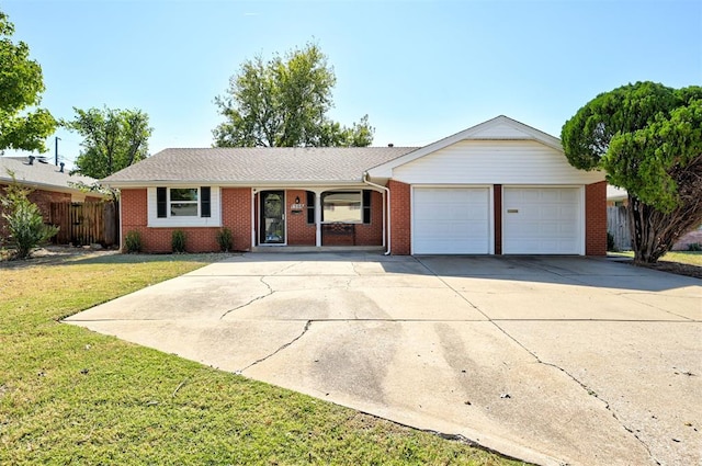 ranch-style house featuring a front yard and a garage