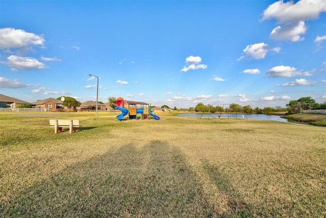 community playground with a water view and a yard