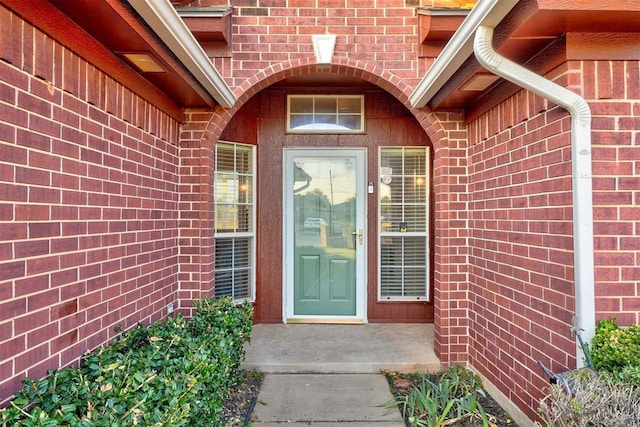 doorway to property with brick siding