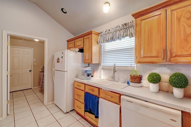 kitchen with light tile patterned floors, light countertops, vaulted ceiling, a sink, and white appliances