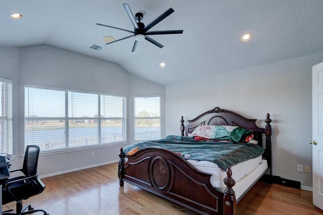 bedroom with recessed lighting, visible vents, vaulted ceiling, wood finished floors, and baseboards