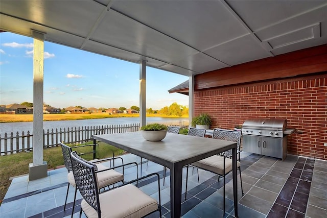 view of patio / terrace with a water view and area for grilling