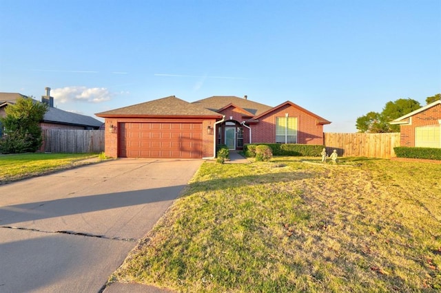 single story home with a garage, concrete driveway, brick siding, and fence