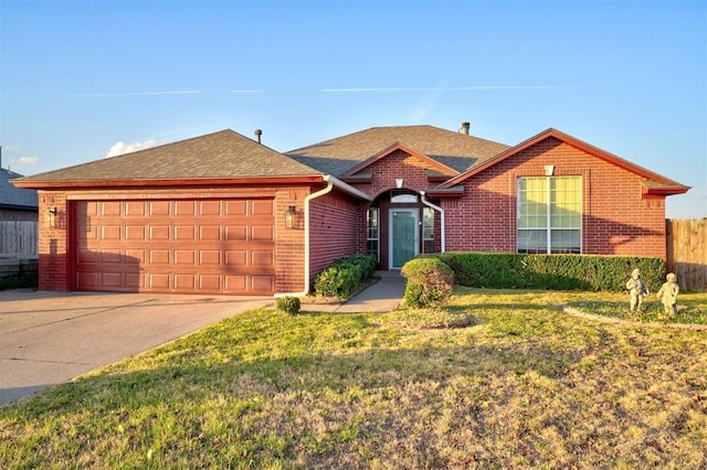 single story home with a front yard, concrete driveway, brick siding, and an attached garage