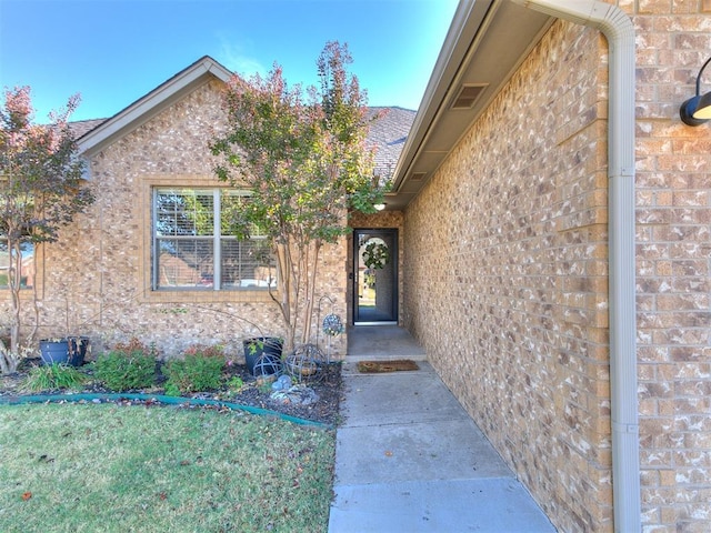 property entrance with a yard