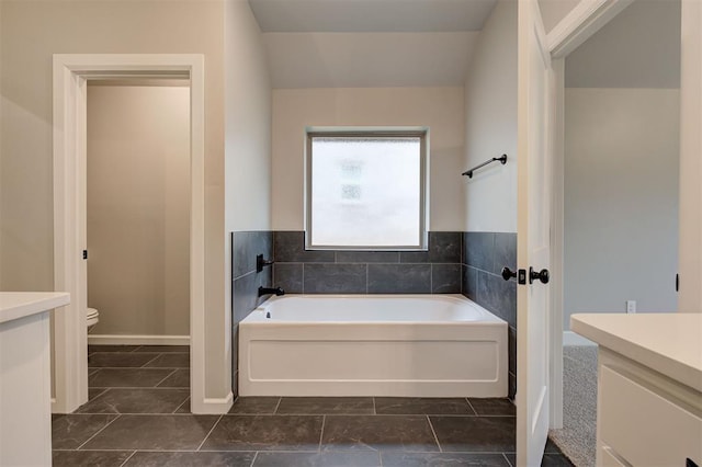 full bathroom with vanity, toilet, and a bath