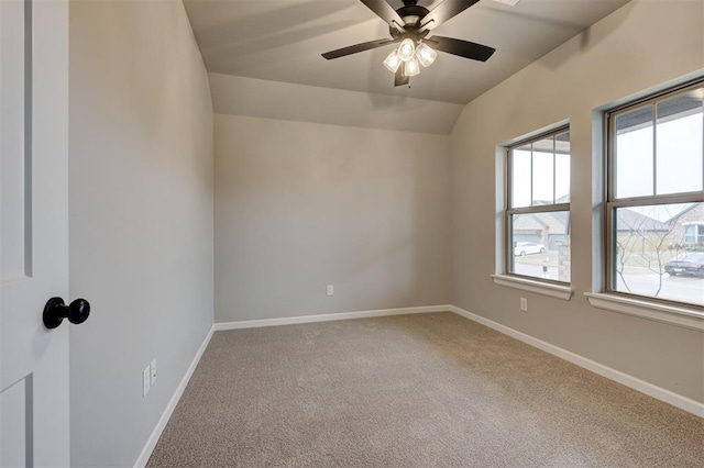 unfurnished room with baseboards, a ceiling fan, lofted ceiling, and carpet flooring