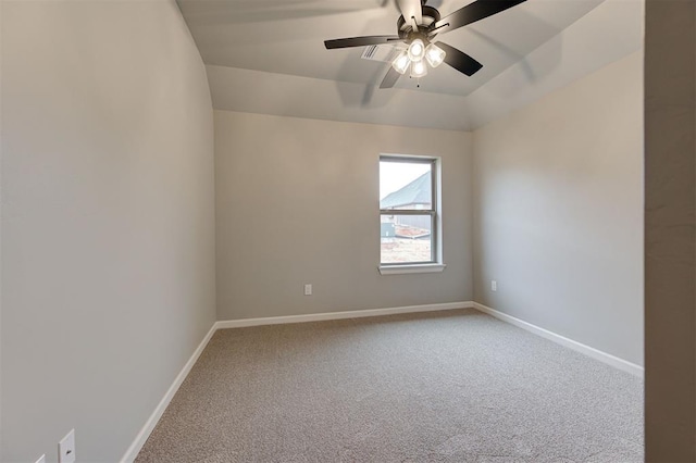 carpeted empty room featuring ceiling fan and baseboards