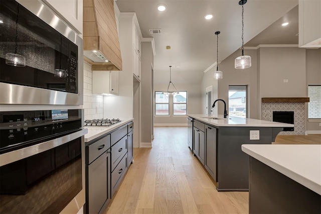 kitchen featuring light countertops, visible vents, appliances with stainless steel finishes, and a sink