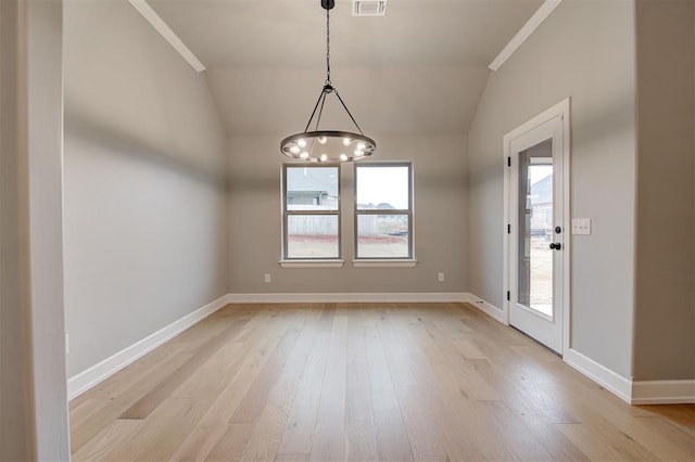 empty room with lofted ceiling, baseboards, light wood-type flooring, and visible vents