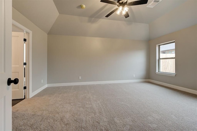 empty room with visible vents, light carpet, lofted ceiling, and baseboards