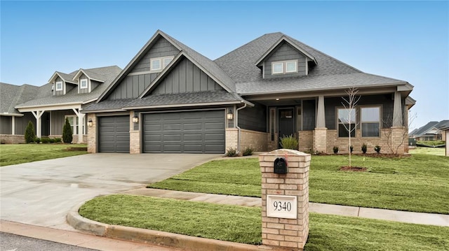 craftsman inspired home featuring brick siding, driveway, a front lawn, and a garage