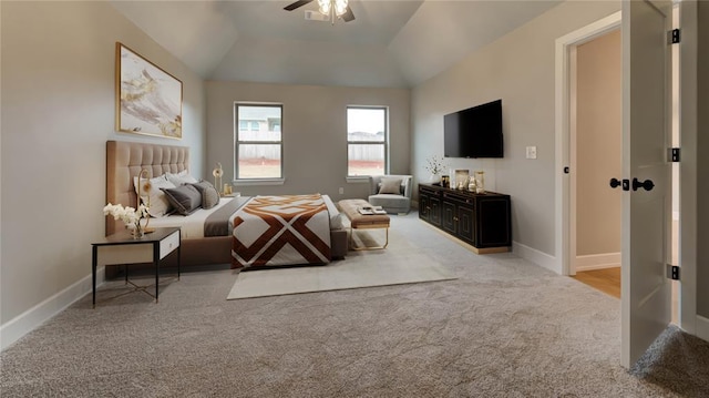 bedroom with a ceiling fan, vaulted ceiling, carpet, and baseboards