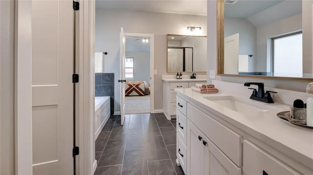 ensuite bathroom with vanity, tile patterned flooring, a shower stall, vaulted ceiling, and a bathtub