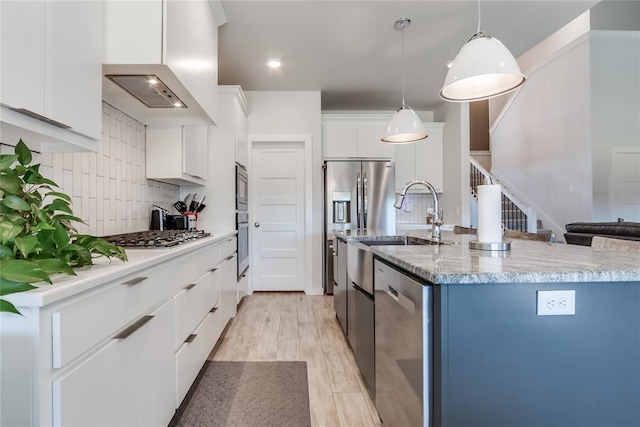 kitchen featuring decorative light fixtures, decorative backsplash, white cabinetry, and stainless steel appliances