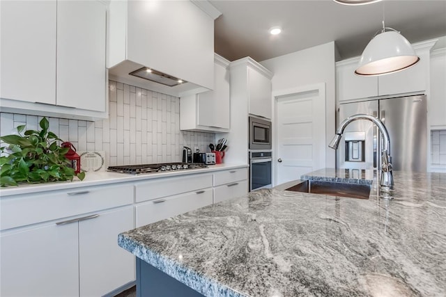 kitchen featuring white cabinets, appliances with stainless steel finishes, and tasteful backsplash