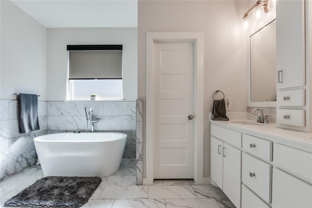 bathroom with a bathing tub, vanity, and tile walls