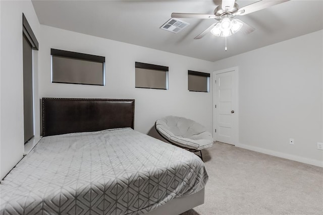 bedroom featuring light colored carpet and ceiling fan