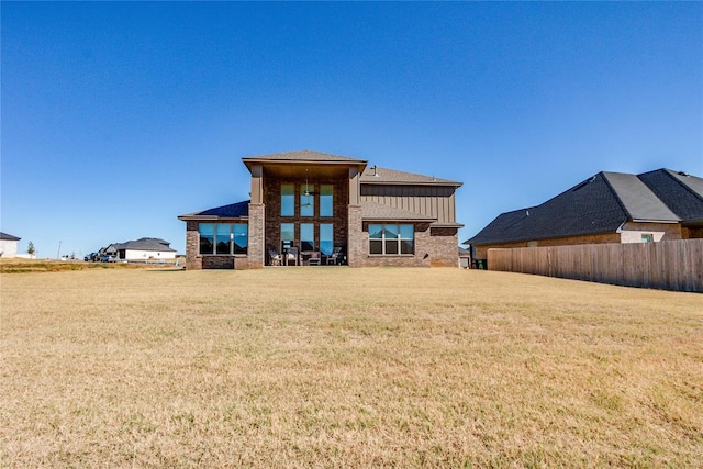 rear view of house with a yard