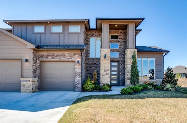 view of front of property with a front yard and a garage