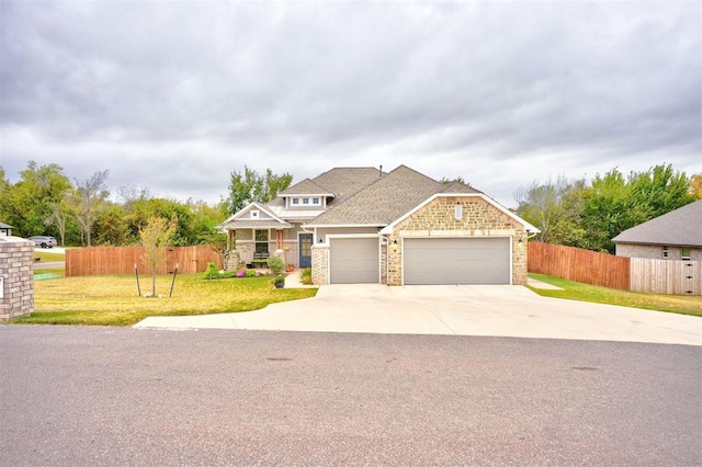 view of front of house with a front yard and a garage