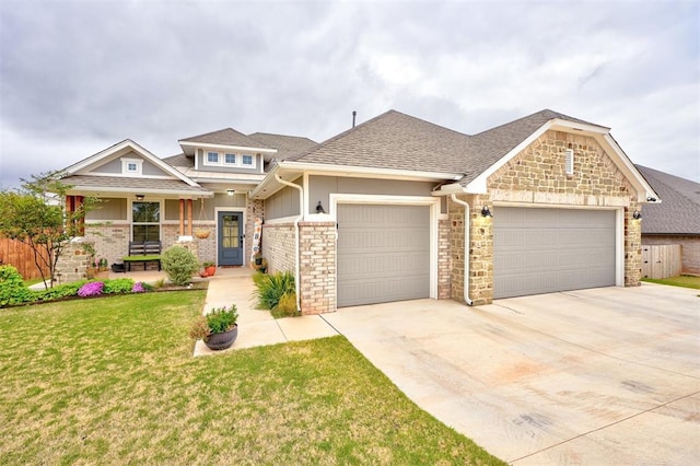 craftsman-style home with covered porch, a garage, and a front lawn