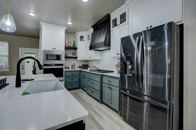 kitchen with white cabinets, gray cabinets, stainless steel appliances, and hanging light fixtures