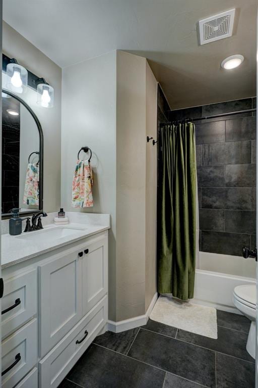 full bathroom with tile patterned floors, shower / bath combo with shower curtain, vanity, and toilet